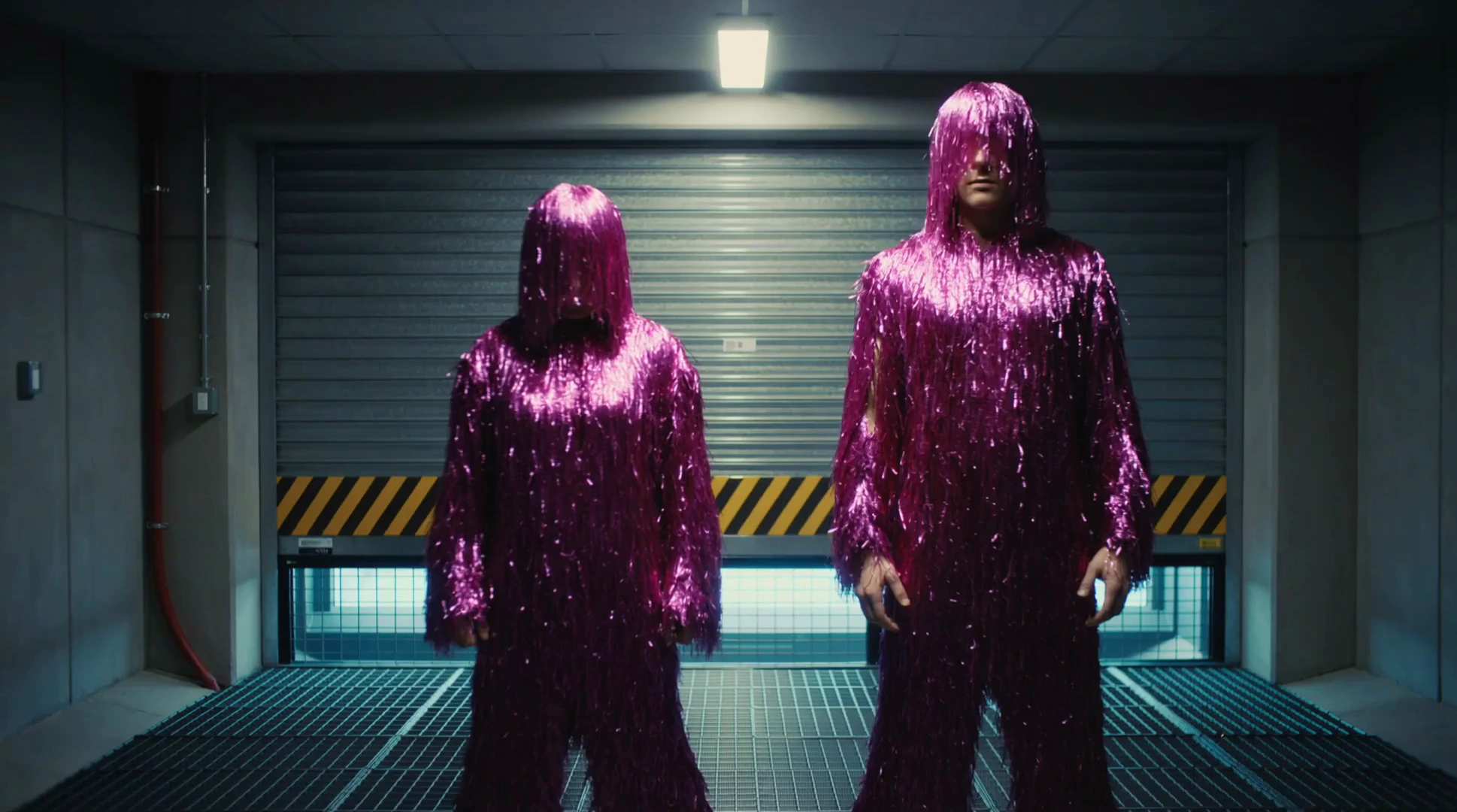 A centered, eye-level shot of two individuals dressed in full-body suits made