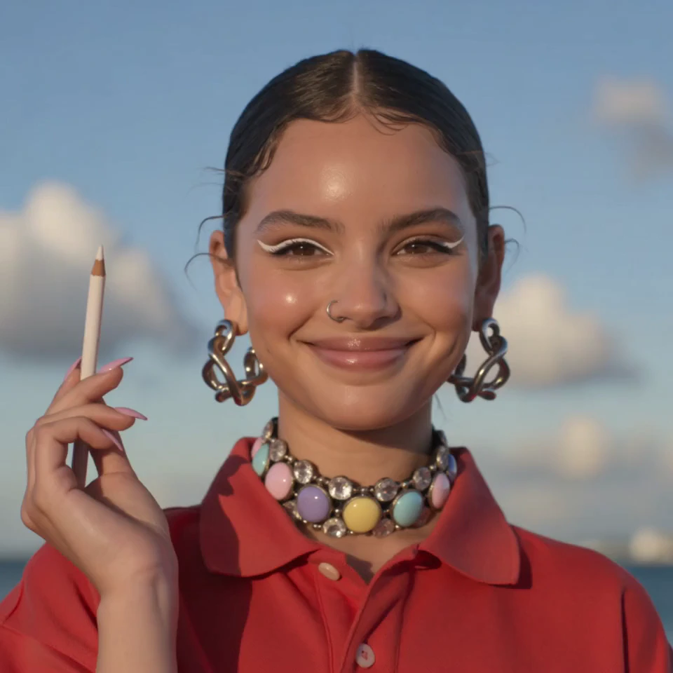 A joyful close-up portrait of a young woman smiling directly into the camera