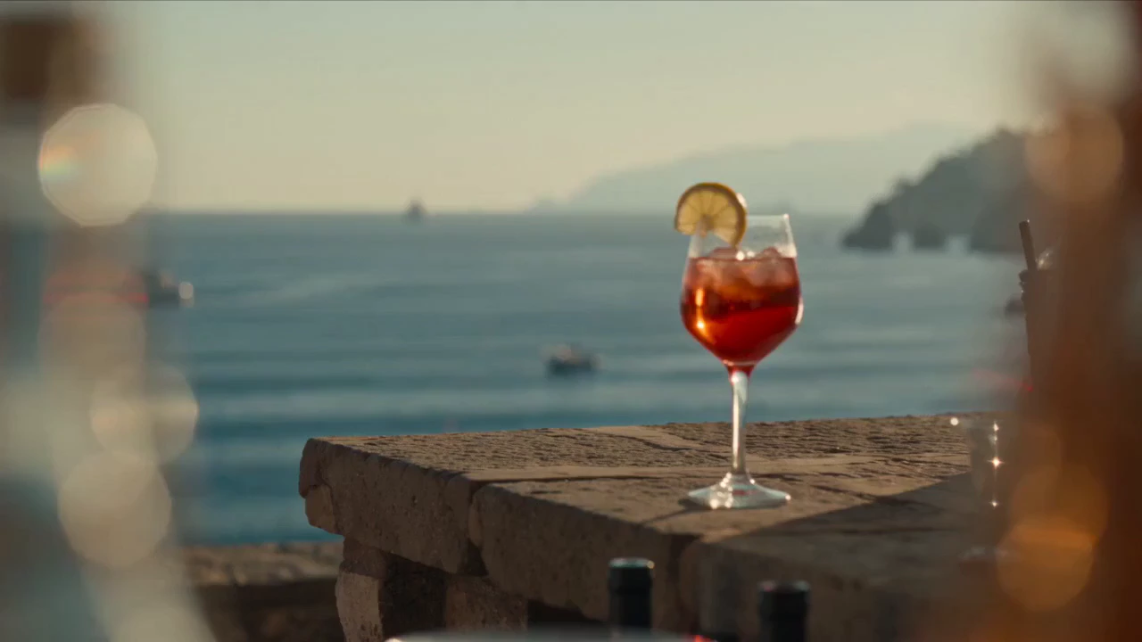 Static handheld shot from a seaside Mediterranean bar terrace overlooking the